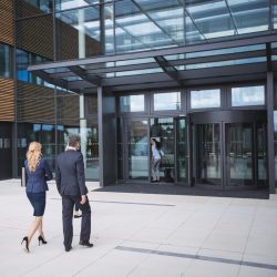 Group of business people entering into an office building